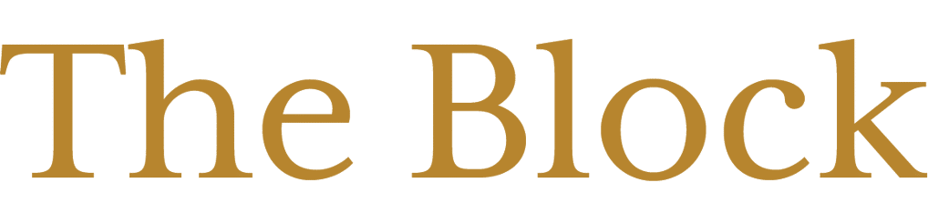 The image shows the words "The Block" in large, gold serif font on a light background.